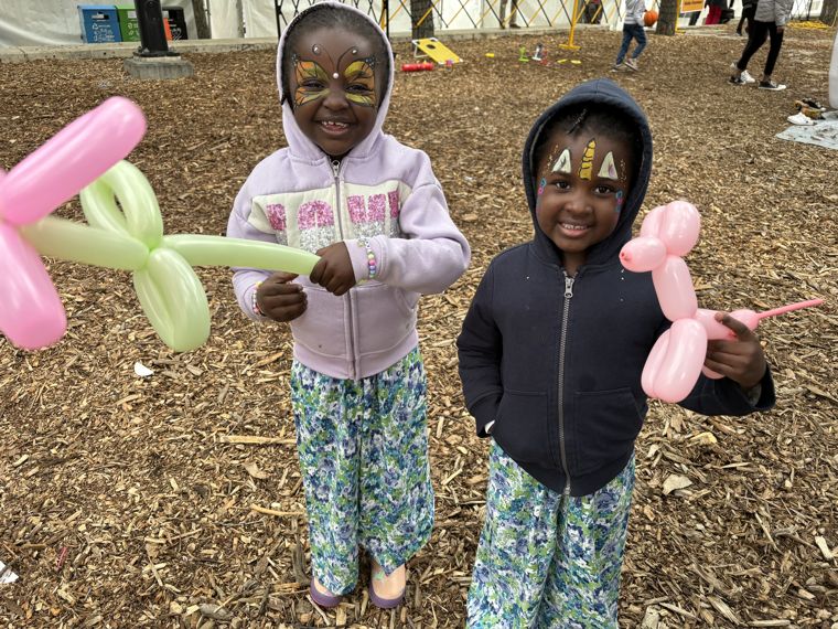 Kids with balloons and face painting at an Edmonton party